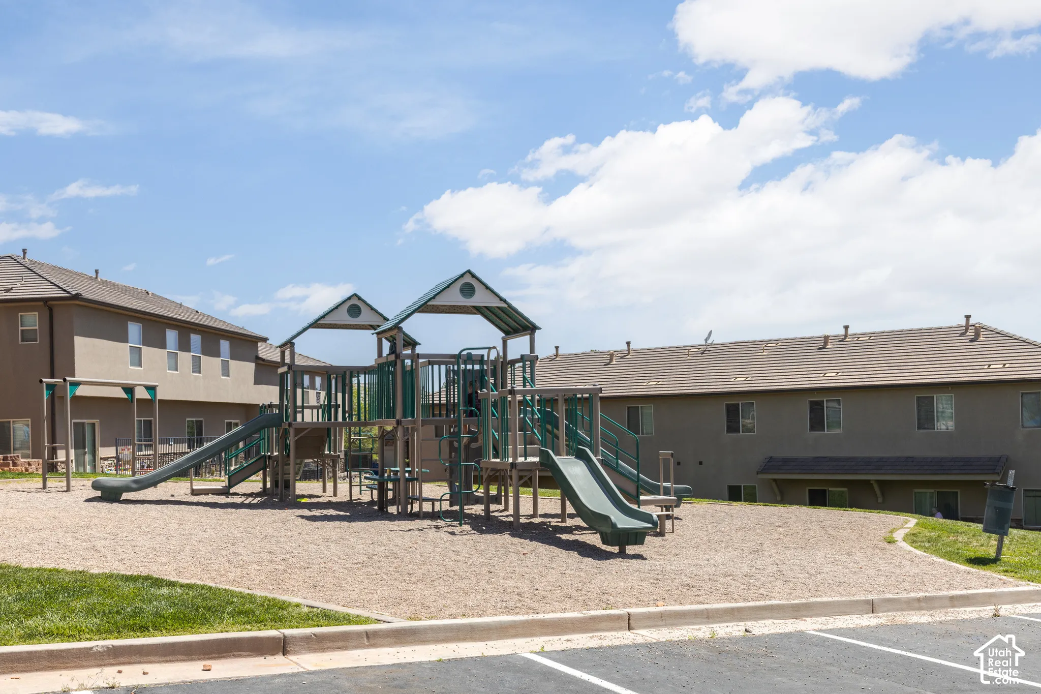 Community playground featuring multiple slides and climbing structures