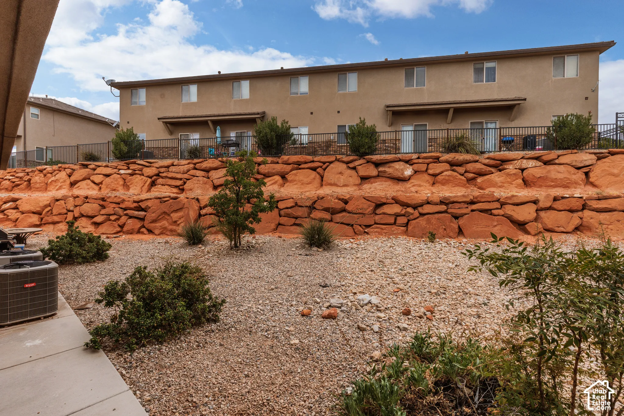 Multi-level stone retaining wall with desert landscaping