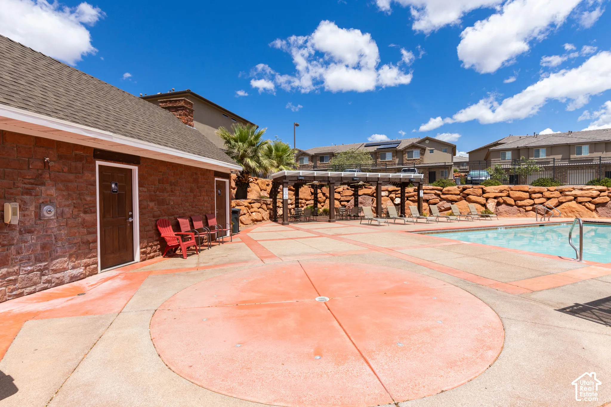 Community swimming pool with a stone coping and a concrete surround