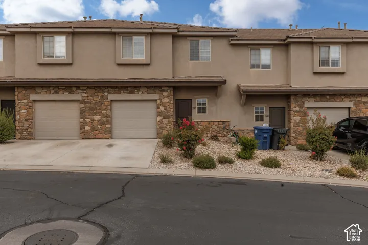 Multi-story exterior with stucco siding and stone accents