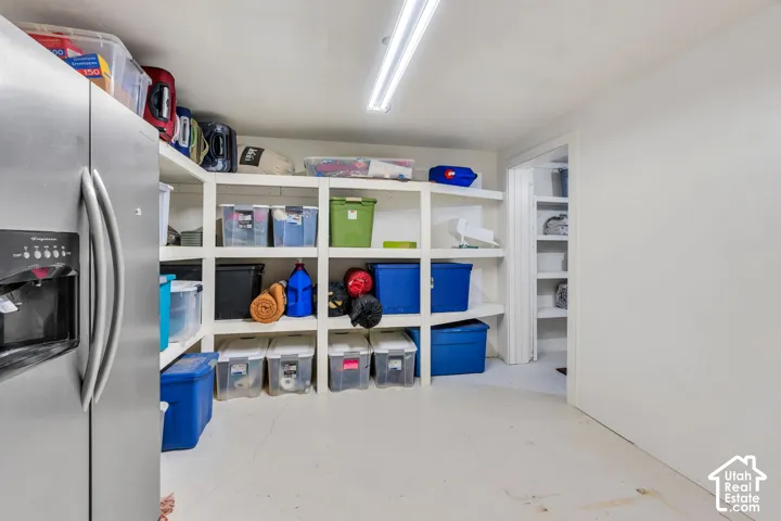 Integrated shelving system, additional storage area, and stainless steel refrigerator