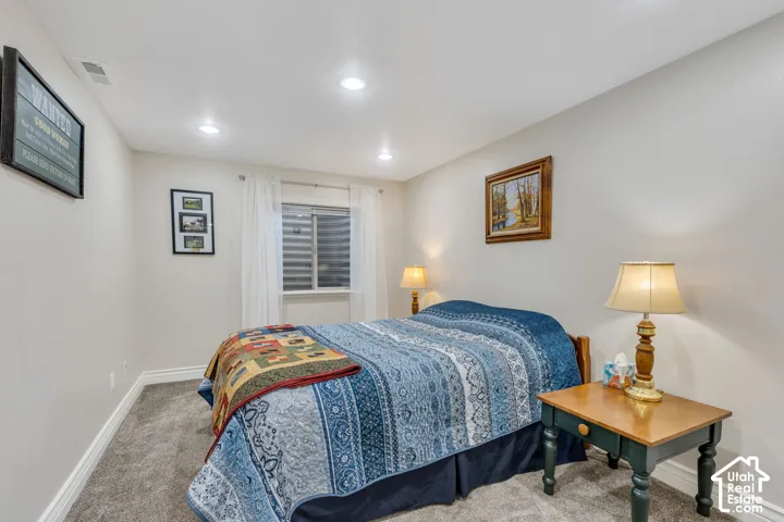 Recessed ceiling lighting, a window with blinds, and light gray wall paint