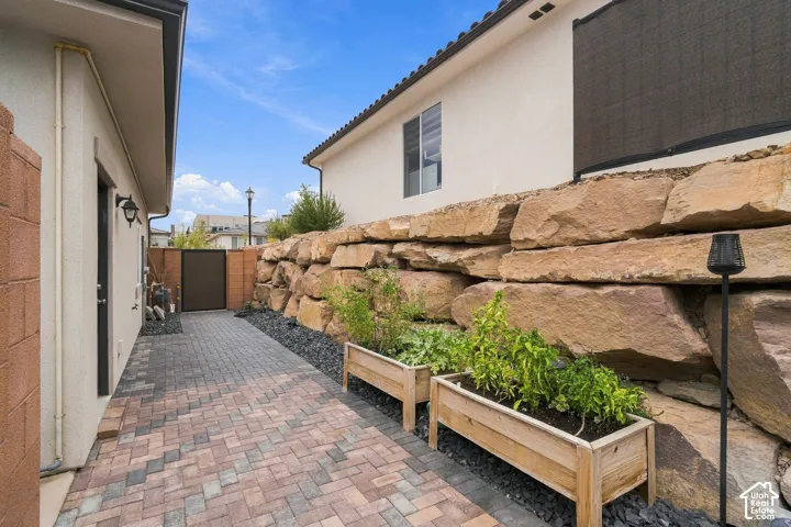 Paver stone walkway with a substantial stacked stone retaining wall