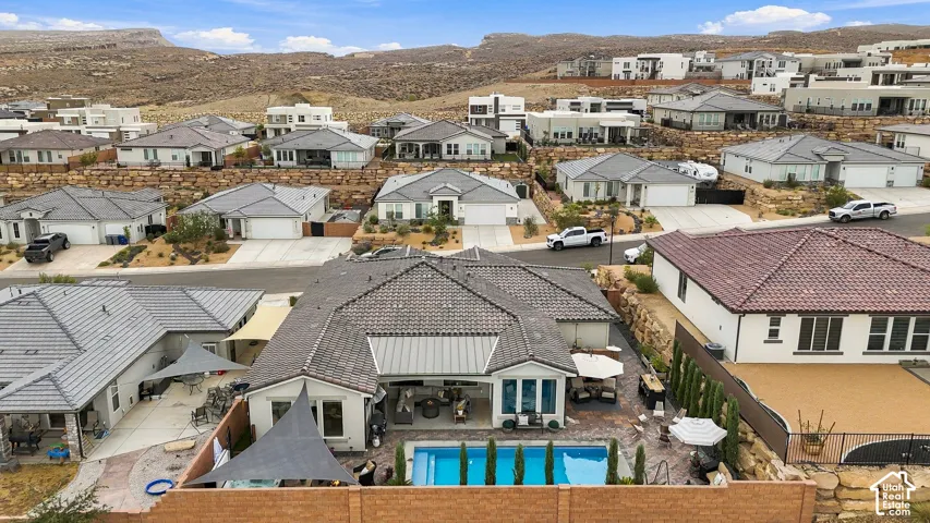 Exterior featuring a swimming pool, covered patio, outdoor dining area, and a privacy fence