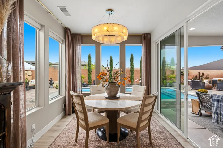 Recessed lighting, wood-finish flooring, and a contemporary chandelier