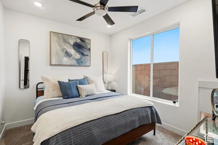 Recessed ceiling lighting, ceiling fan, large window, and carpeted flooring