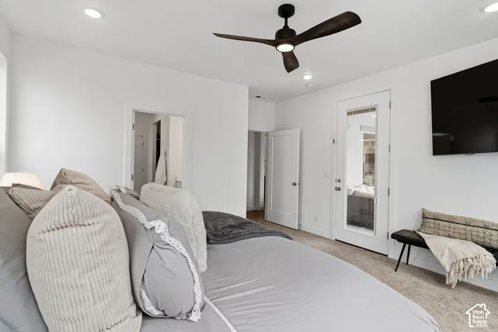 Recessed ceiling lighting, ceiling fan with integrated lighting, glass-paneled door, and neutral-toned carpeting