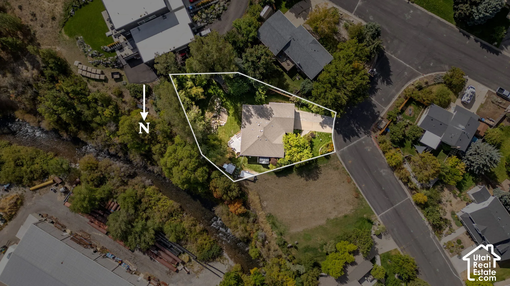 Property featuring a gabled roofline, mature trees, and landscaping
