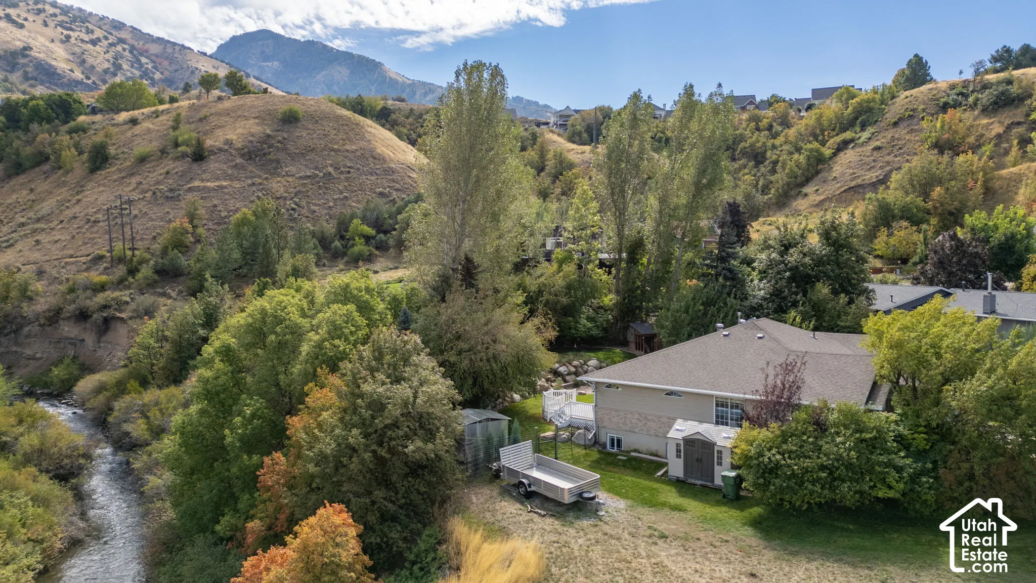 Expansive property featuring a river, natural foliage, and mountainous terrain