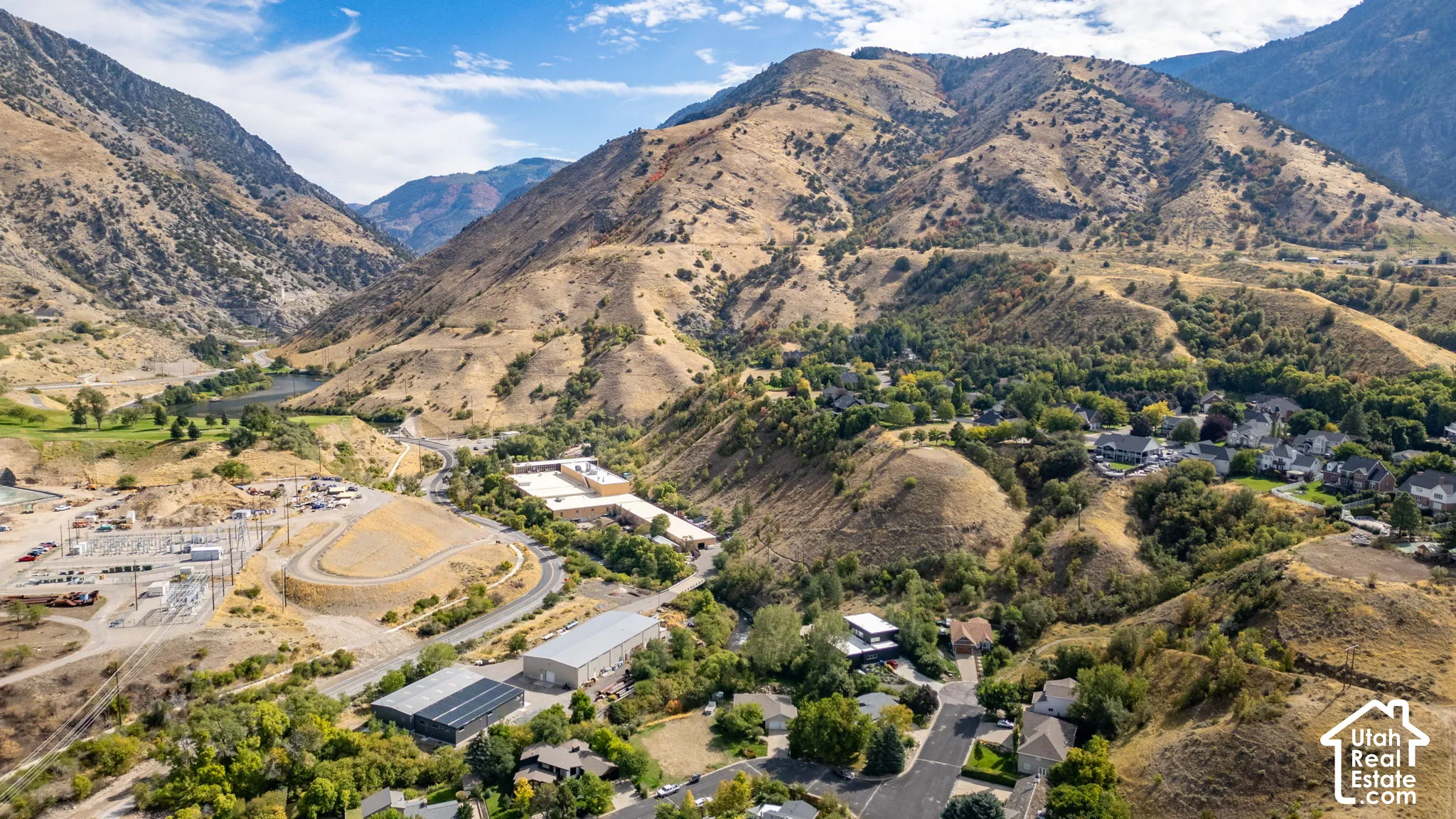 Mountainous terrain with natural vegetation and a distant body of water