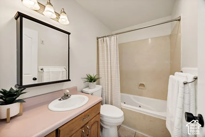 Vanity with a built-in sink, wood-finish cabinetry, and a framed mirror