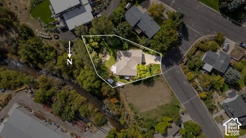 Property featuring a gabled roofline, mature trees, and landscaping