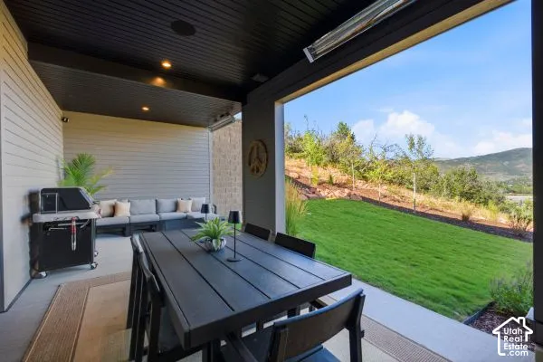 Covered patio with recessed lighting, integrated ceiling speakers, and mounted heaters. The photos are renderings only - these photos are for a similar unit in Discovery Ridge. Not this actual model.