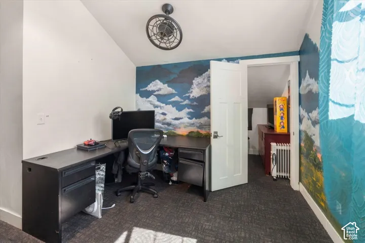 Angled ceiling room with textured carpeting