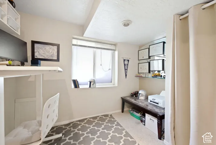 Recessed window with blinds, built-in shelving, glass shelving, and a wall-mounted curtain rod