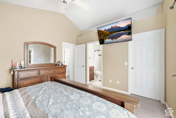 Vaulted ceiling with ceiling fan, light neutral wall paint, and white trim