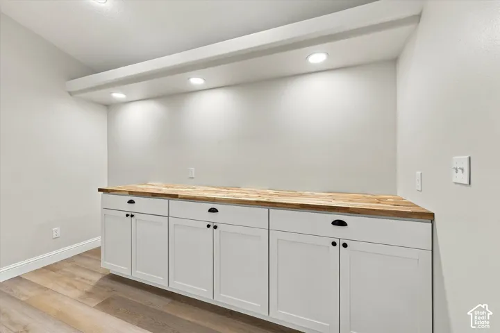 Butler Pantry - Built-in cabinetry with white shaker-style doors and black hardware
