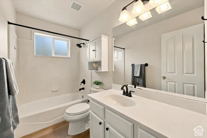White vanity with a single basin sink and white countertop