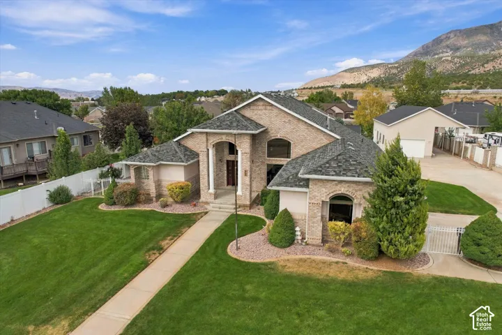 Brick exterior residence with an arched entry and column details