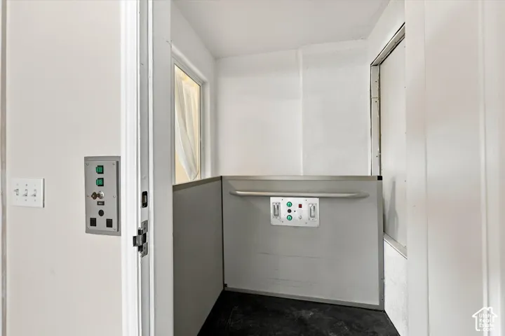 Elevator - Interior vertical lift with control panel and grab bar