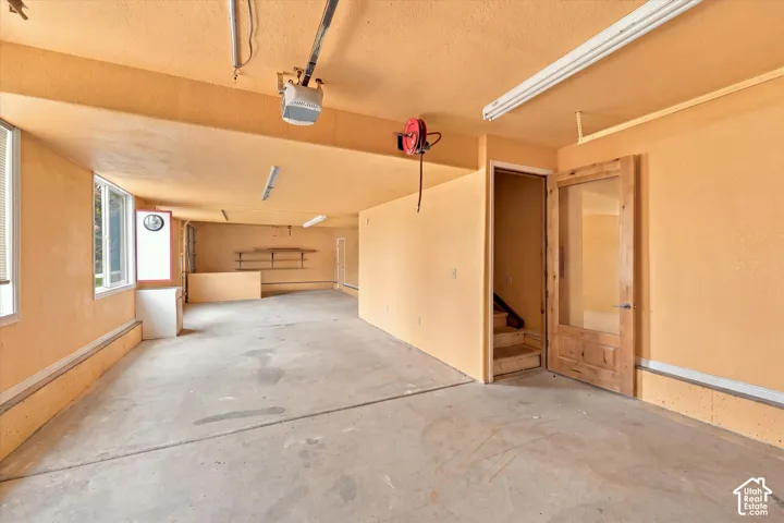 Large Outbuilding. Concrete flooring with a built-in workbench, shelving, and recessed lighting