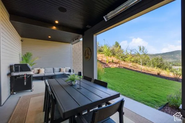 Covered patio with recessed lighting, integrated ceiling speakers, and mounted heaters