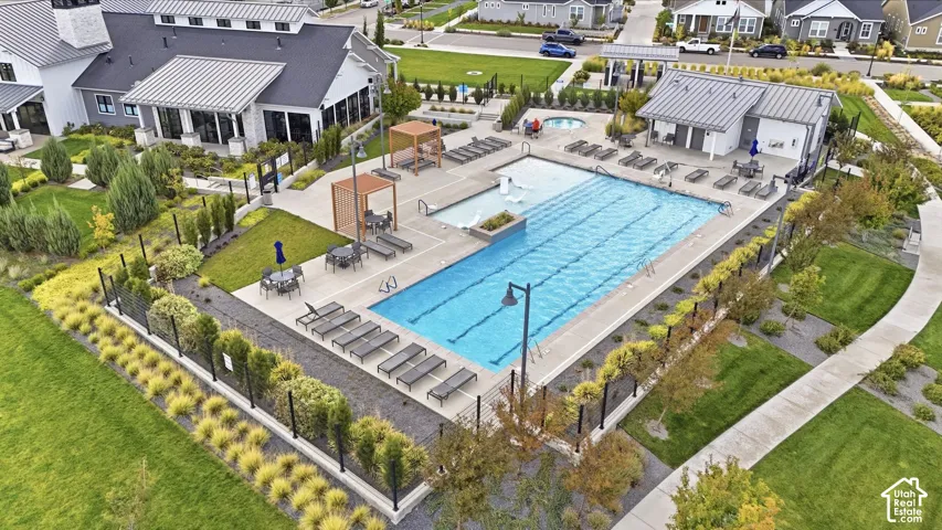 Community pool with lap lanes, adjacent spa, and surrounding lounge areas