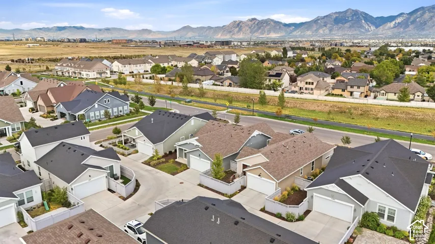 Residential streetscape with a variety of single-family homes, each featuring a pitched roof and attached garages