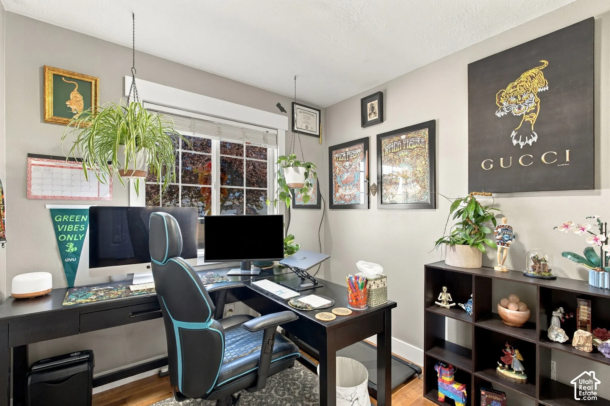 Bedroom used as an office wood-finish flooring with neutral wall tones