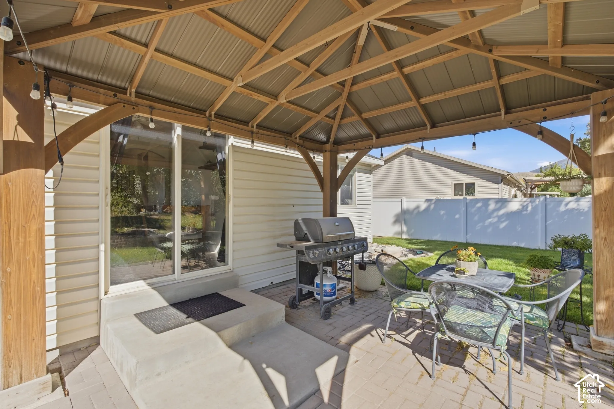 Covered outdoor patio with wood-framed structure and corrugated metal roof