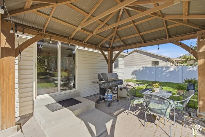 Covered outdoor patio with wood-framed structure and corrugated metal roof