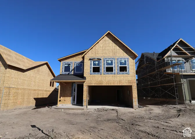 New construction framing with multiple window placements and an integrated garage