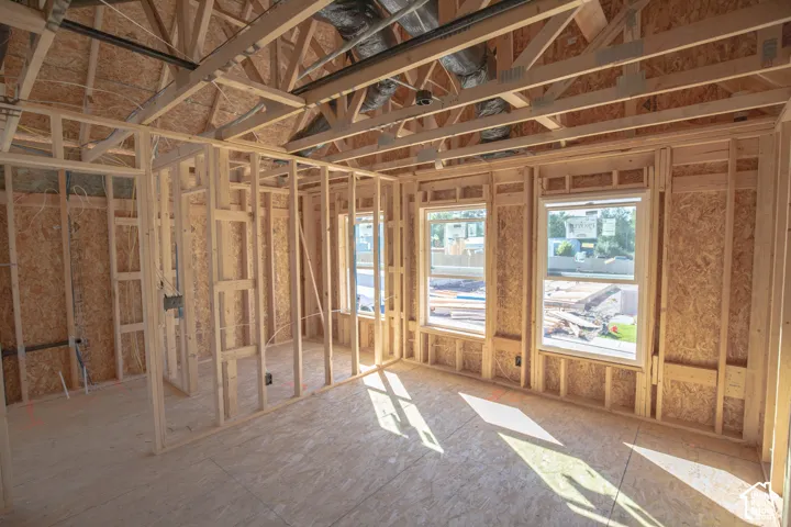 New construction framing showcasing structural integrity, exposed trusses, and multiple window openings