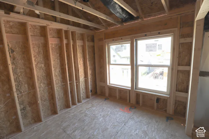New construction framing with wood studs, oriented strand board sheathing, and two double-hung windows