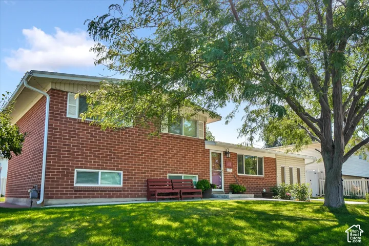 Brick exterior with white window trim and shutters