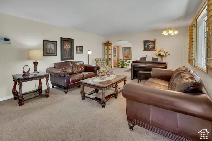 Arched doorway, interior lighting fixture, window with slatted shutters, wood-finish flooring