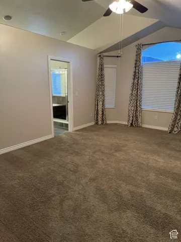 Vaulted ceiling with recessed lighting and ceiling fan