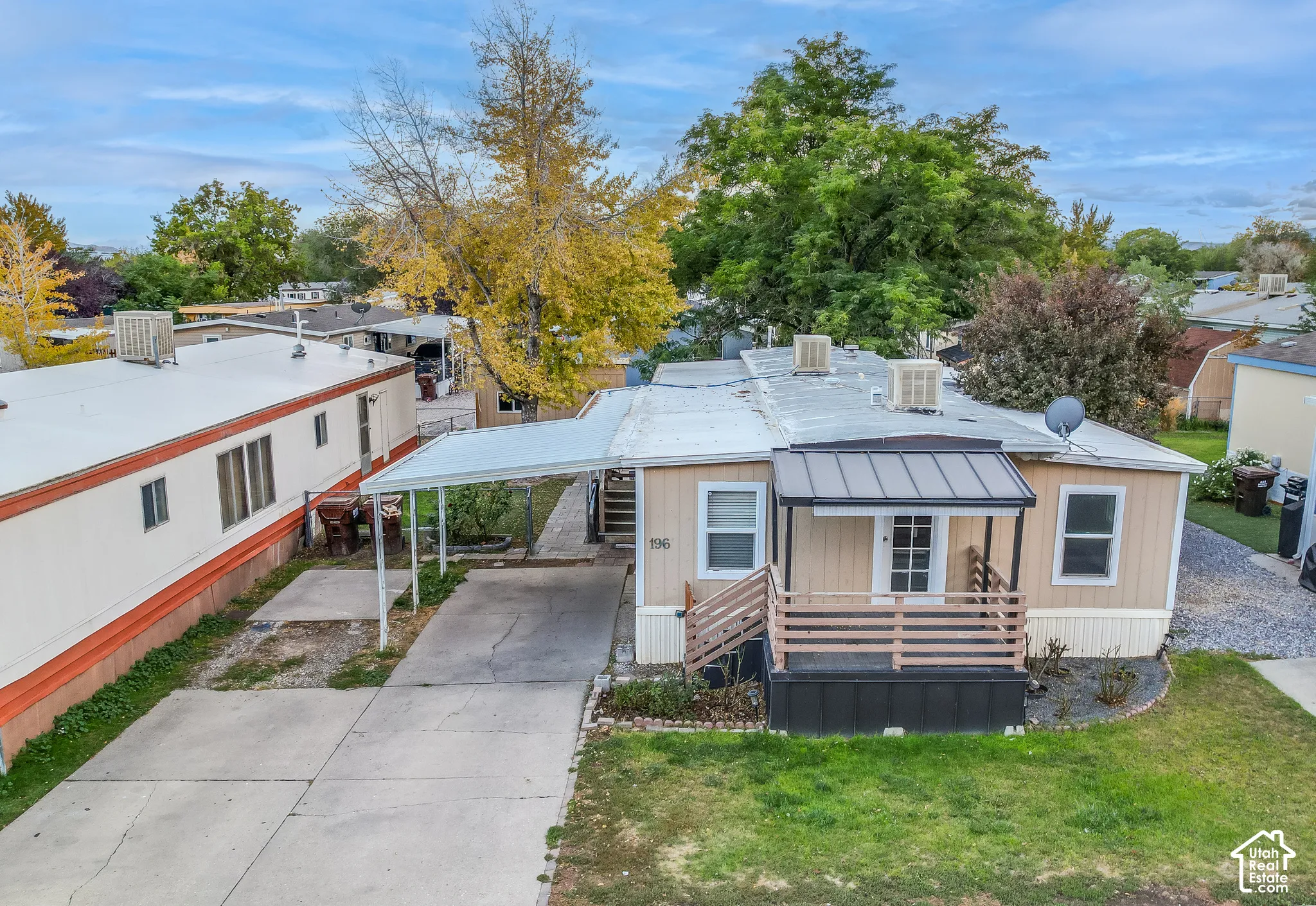 Front exterior with a covered entry, a metal awning, and a carport