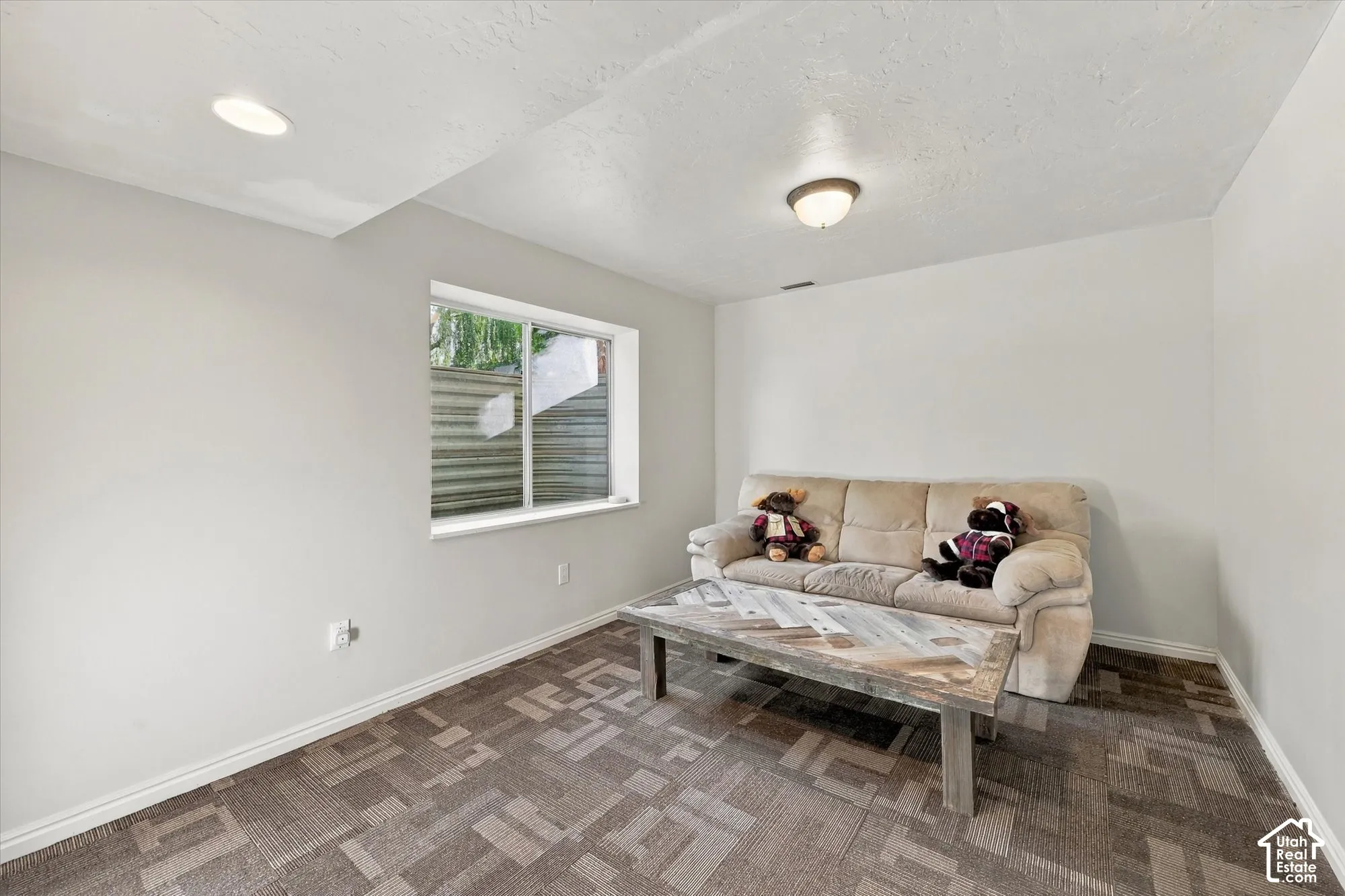 Recessed ceiling lighting, flush mount ceiling fixture, window, and patterned carpet