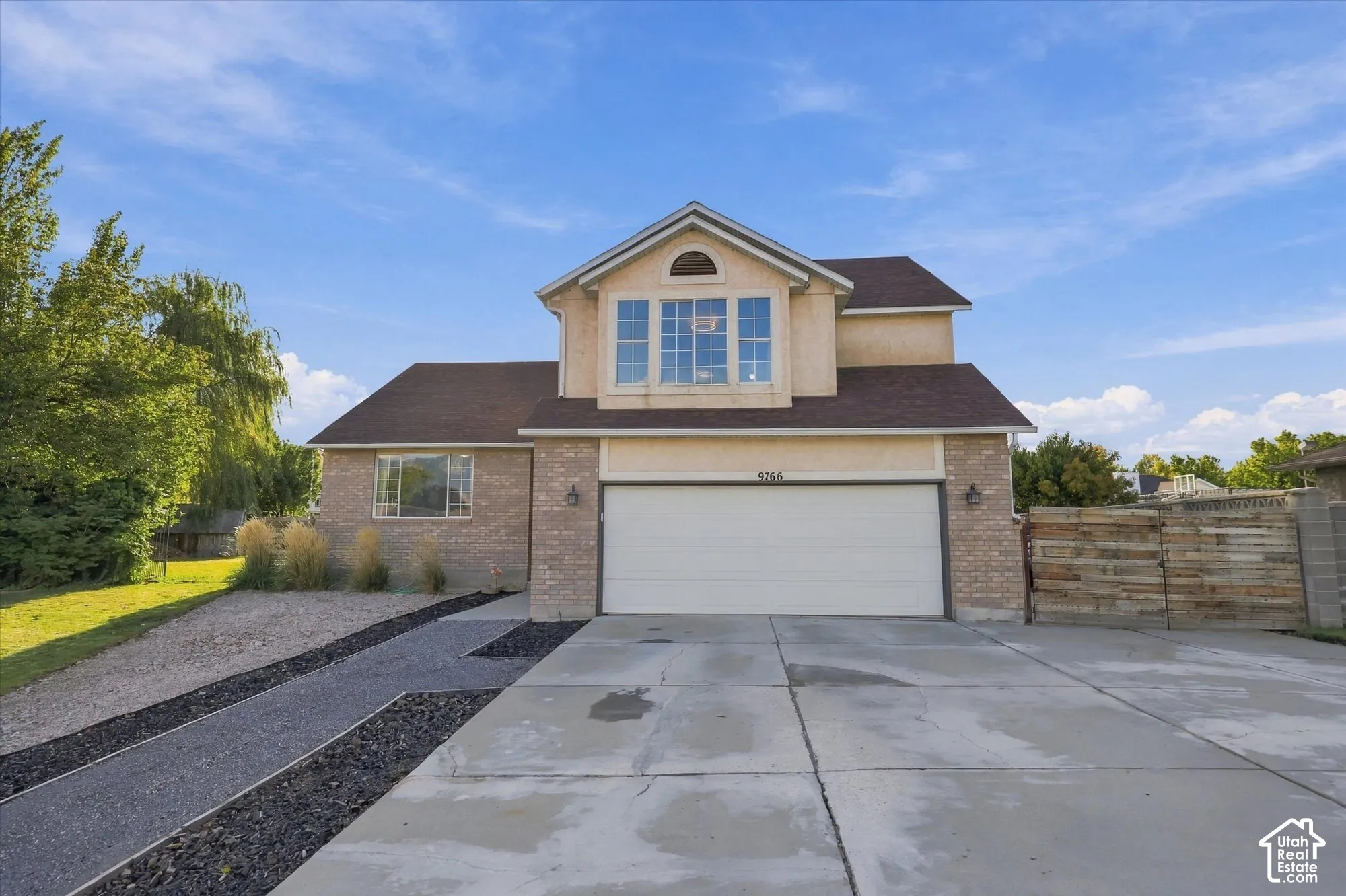 Two-story stucco and brick exterior with a big windows