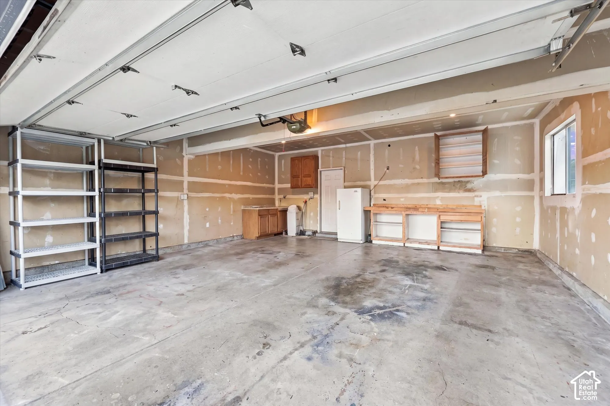 Concrete flooring, built-in cabinetry, and window