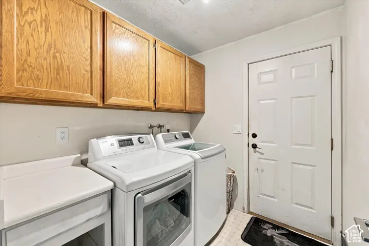 Upper wood-finish cabinetry, white countertop, and white paneled door