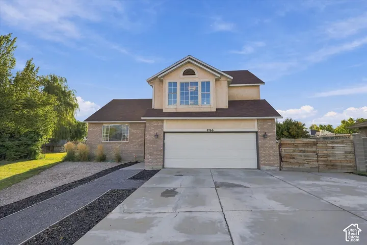Two-story stucco and brick exterior with a big windows