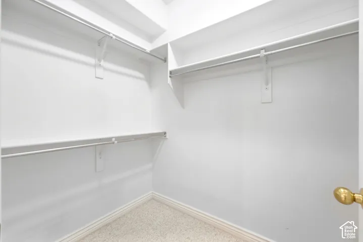 White walls with built-in shelving and hanging rods