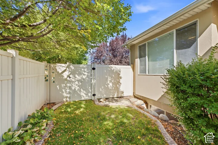 Private fenced yard with established landscaping and mature trees