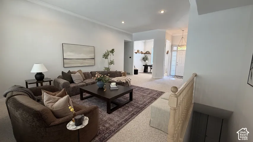 Spacious living area featuring recessed lighting and crown molding