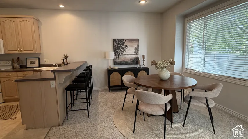 Kitchen featuring wood-finish cabinetry and a built-in breakfast bar with seating