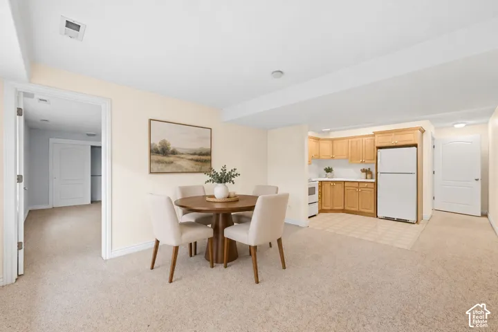 Mother in law, Integrated kitchen with wood-finish cabinetry, white appliances, and tiled flooring