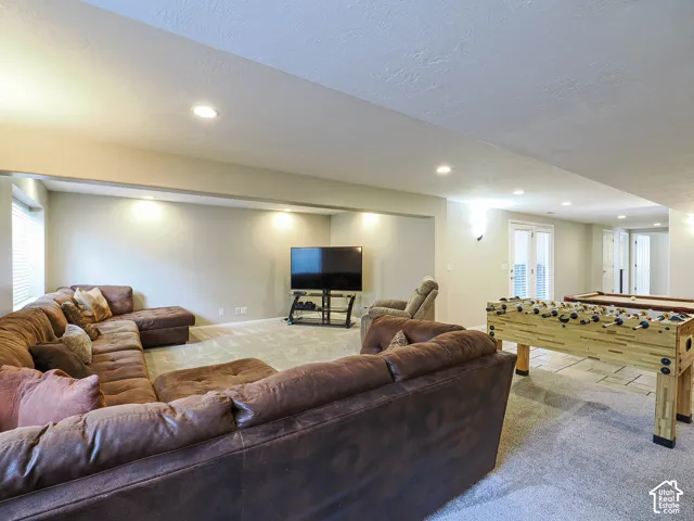 Recessed lighting, light gray walls, light gray carpet, white double doors, and white blinds