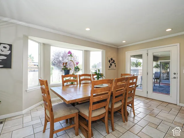 Recessed lighting, crown molding, a bay window, and French doors with glass panes